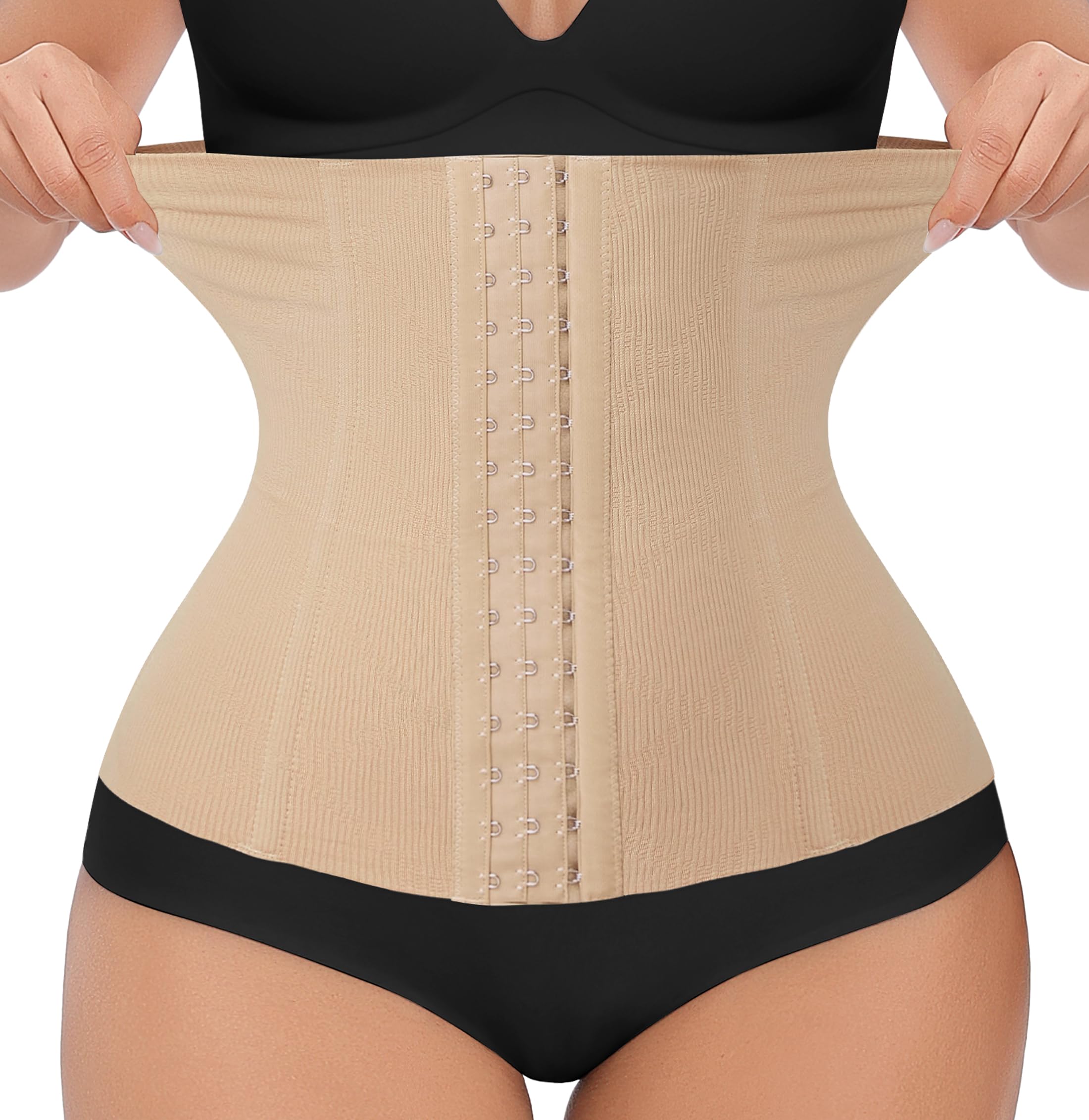 A beige waist trainer corset with adjustable hooks, made of nylon and elastane, being worn over black underwear.