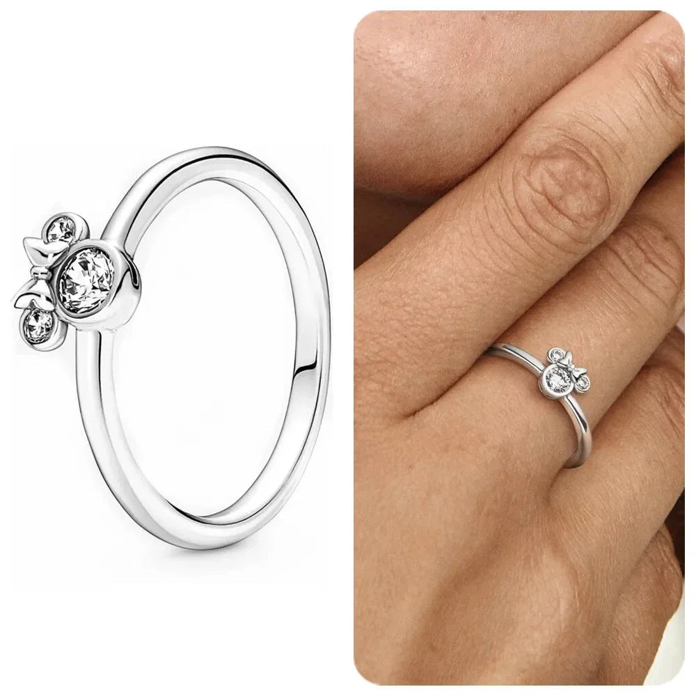 Silver ring with a small decorative element on a white background, featuring the Disney logo.